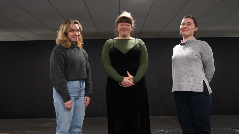 Butt Three women standing in a room smiling