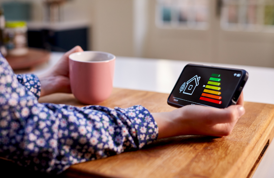EPC rating A person holding their mobile phone in their hand with an EPC rating on the screen