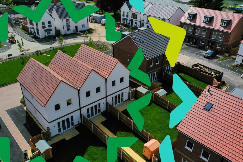 Aerial photograph of a housing development with terraced, semi-detached and detached homes with gardens separated by wooden fences