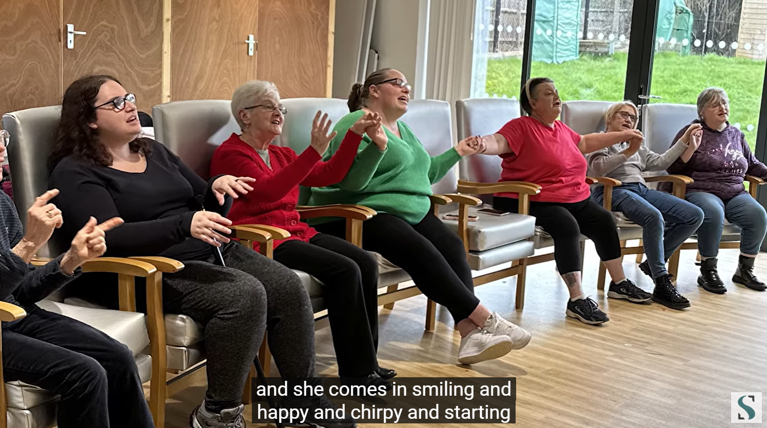 Sanctuary residents sat in a hall singing in the choir