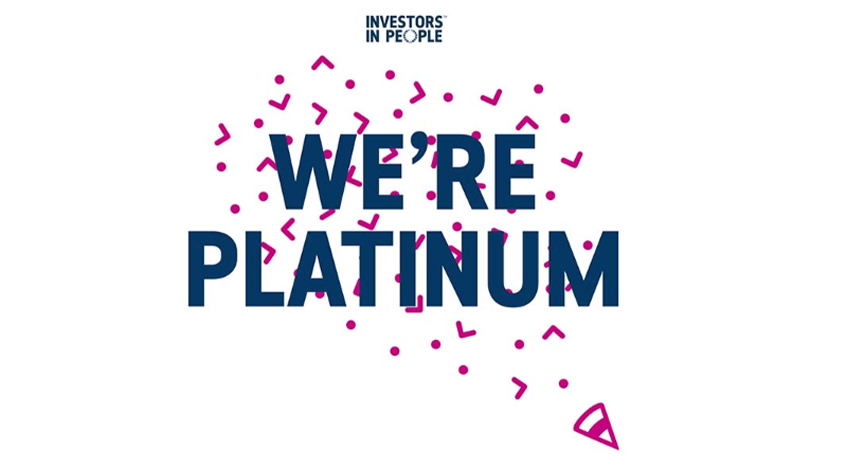 Graphic with the Investors in People logo at the top and bold text reading 'We’re Platinum' in dark blue, surrounded by pink confetti shapes on a white background.