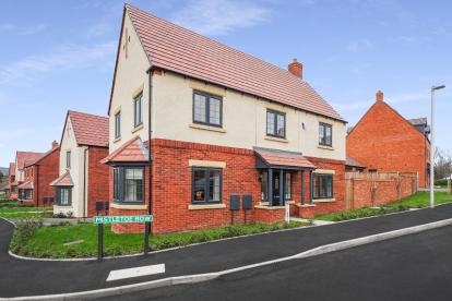 Modern two-storey brick and cream house on Mistletoe Row with red roof, black windows and landscaped front garden.