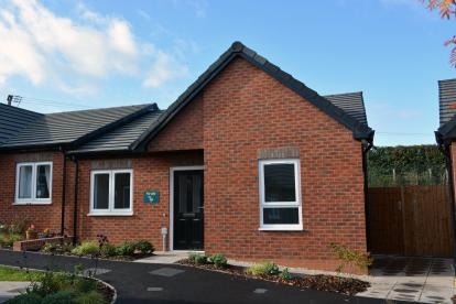 A red brick semi-detached bungalow