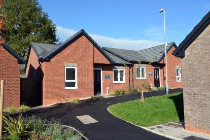 A red brick semi-detached bungalow