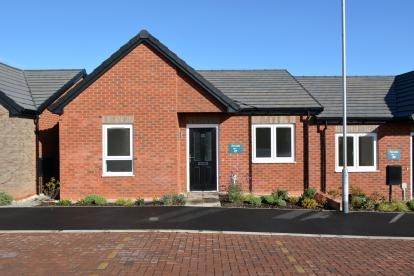 A red brick semi-detached bungalow