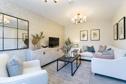 A white walled living room with plush white sofas and a large gridded mirror with black framing