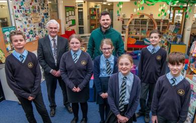 Children, construction manager and head teacher in the new library at St Barnabas school