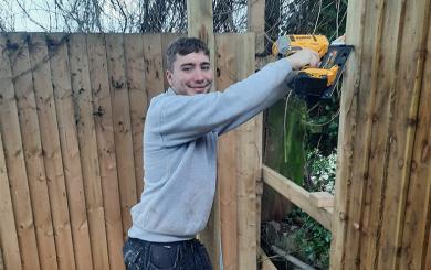 A member of Sanctuary staff putting up new fences for the Acorn Community Centre