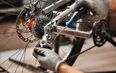 Stock image of a mechanic working on a bicycle chain