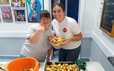 Helpers sort through donated potatoes