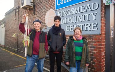 Three people are shown in front of a sign reading Kingsmead Community Centre