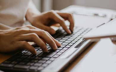 A close up of someone typing on a keyboard