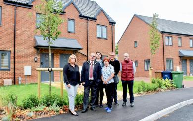 Sanctuary staff members and local councillors stood outside of affordable homes in March
