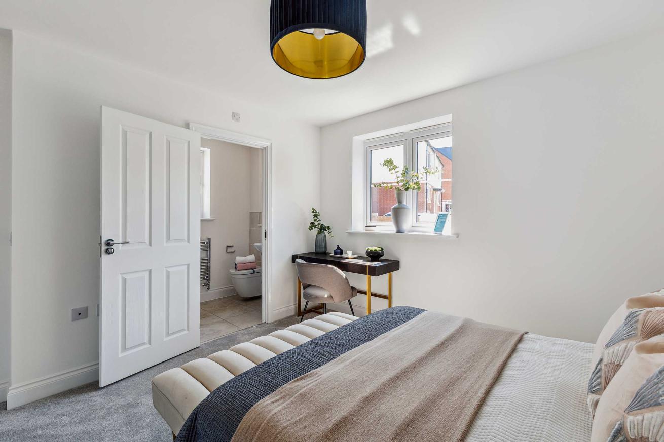  Bright bedroom with double bed, bedside tables, and window.