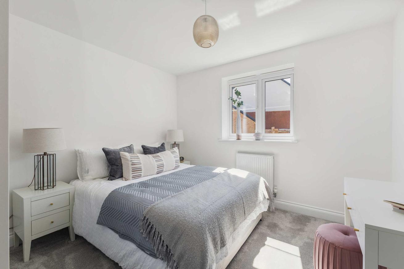 Bedroom with double bed, two bedside tables, and window