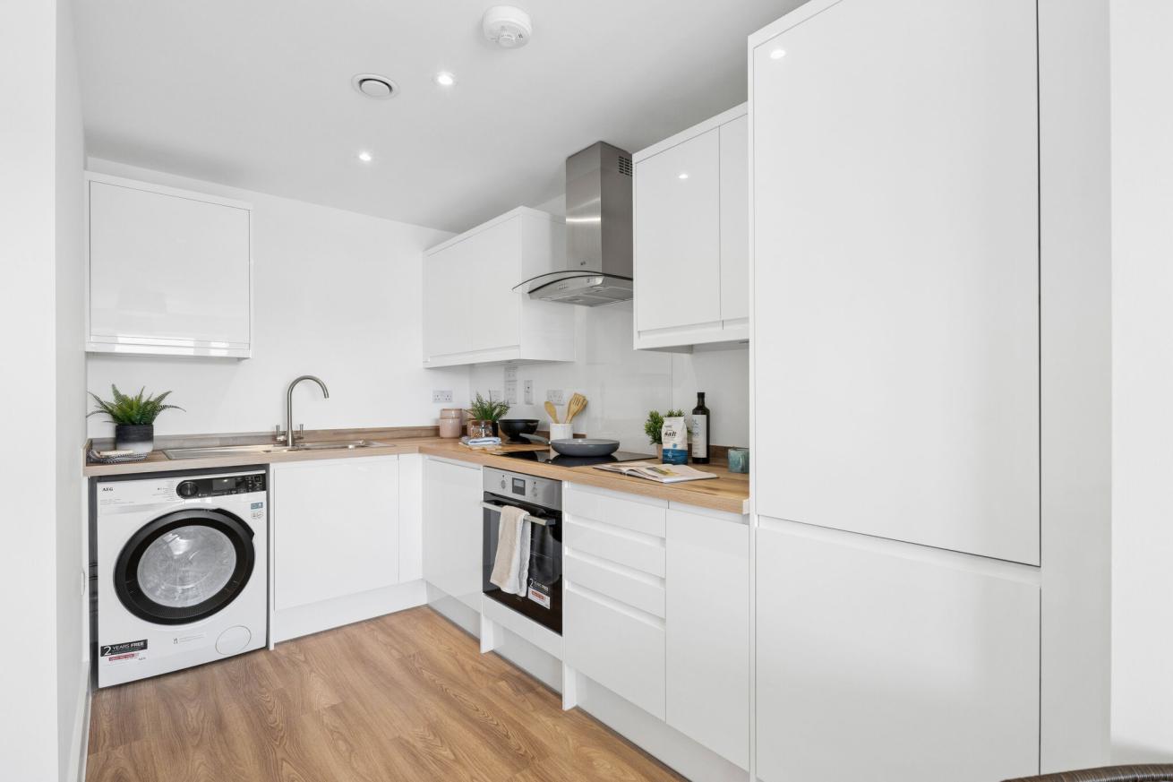 Contemporary white kitchen with oven and washer/dryer