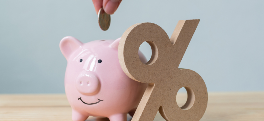 Money being deposited into a piggy bank