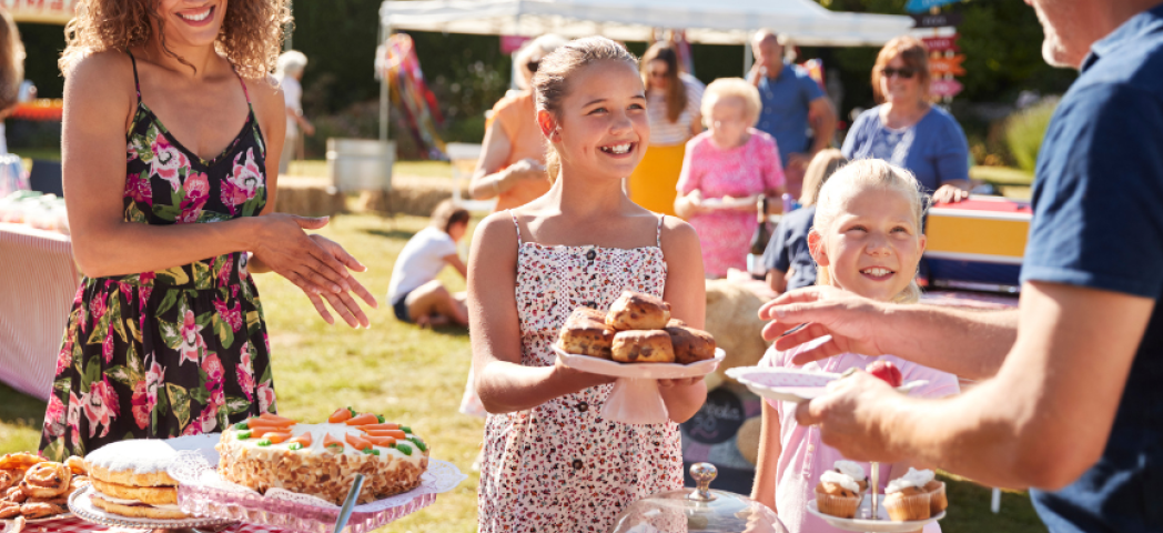 Image of people of all ages enjoying a summer fete on a summers day