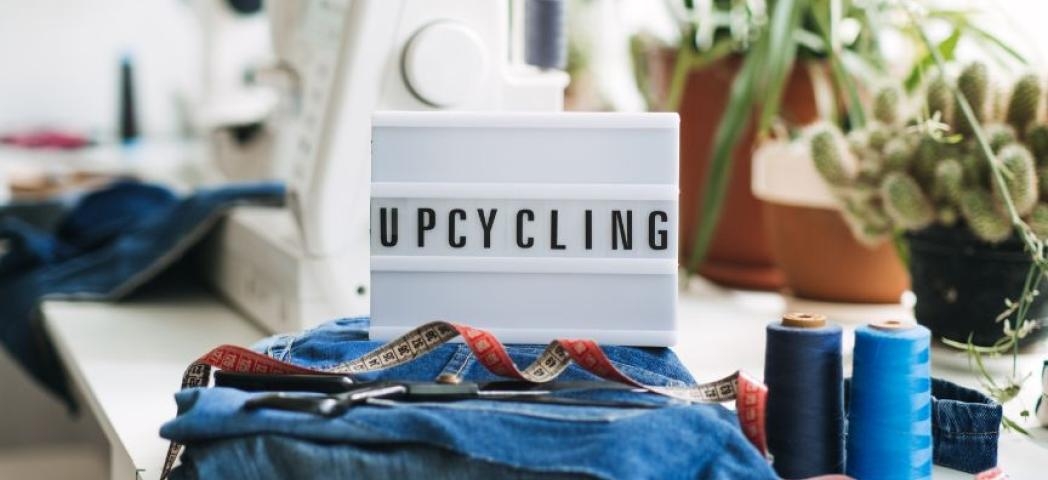 A lightbox placed on a desk spelling out upcycling.
