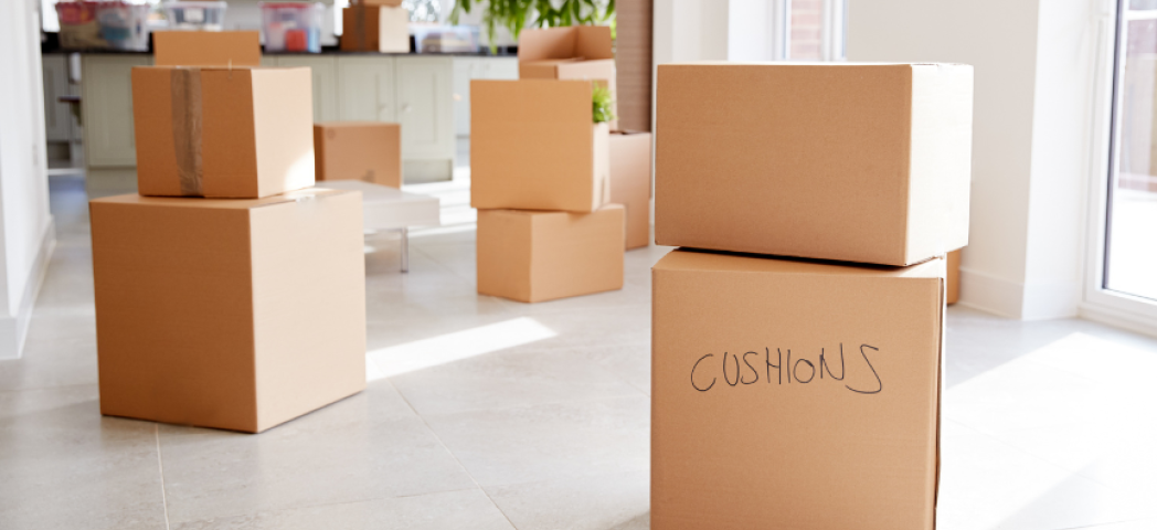 A pile of moving boxes spread across the floor