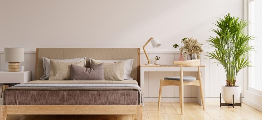 A modern, minimalistic bedroom decorated with beige tones