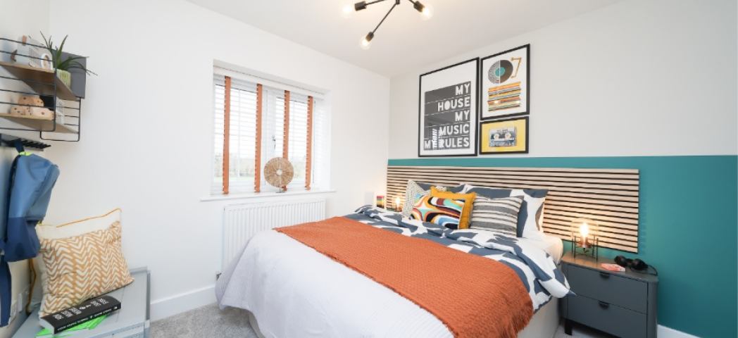 A brightly lit double bedroom finished with modern décor. 