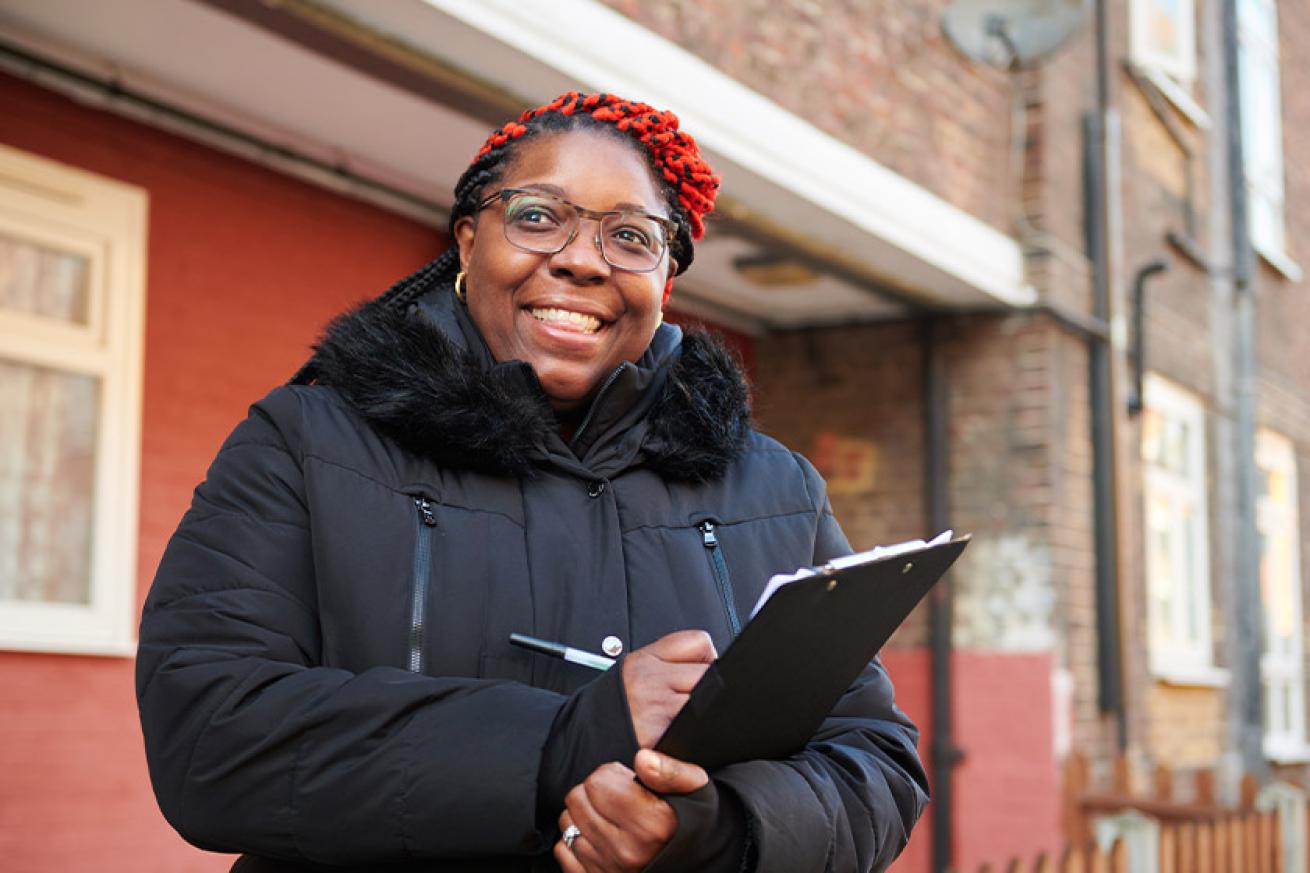 Sanctuary staff member smiling and holding a clipboard