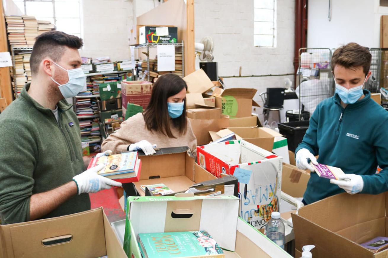 Sanctuary employees sorting through books Sanctuary employees sorting through books
