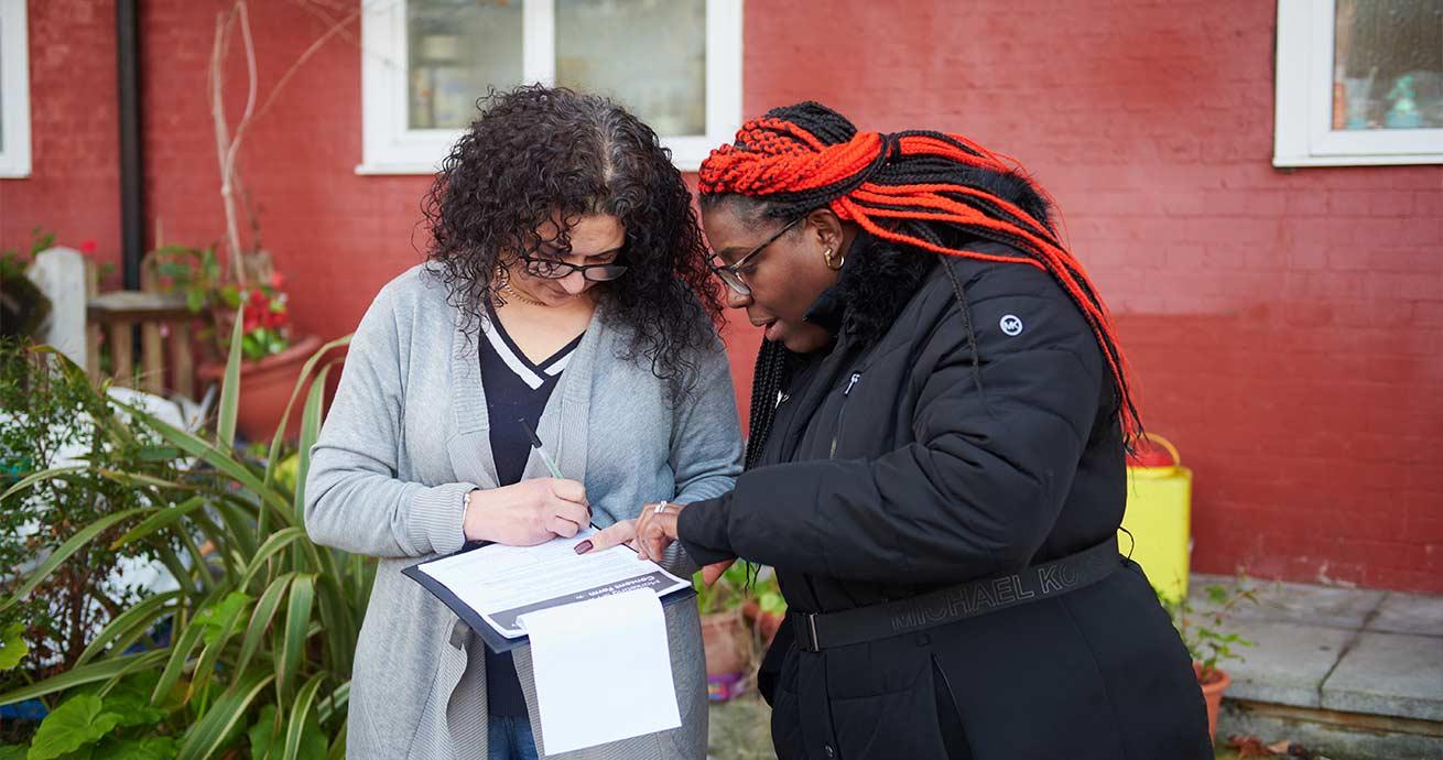 Sanctuary staff member gathering feedback from a resident