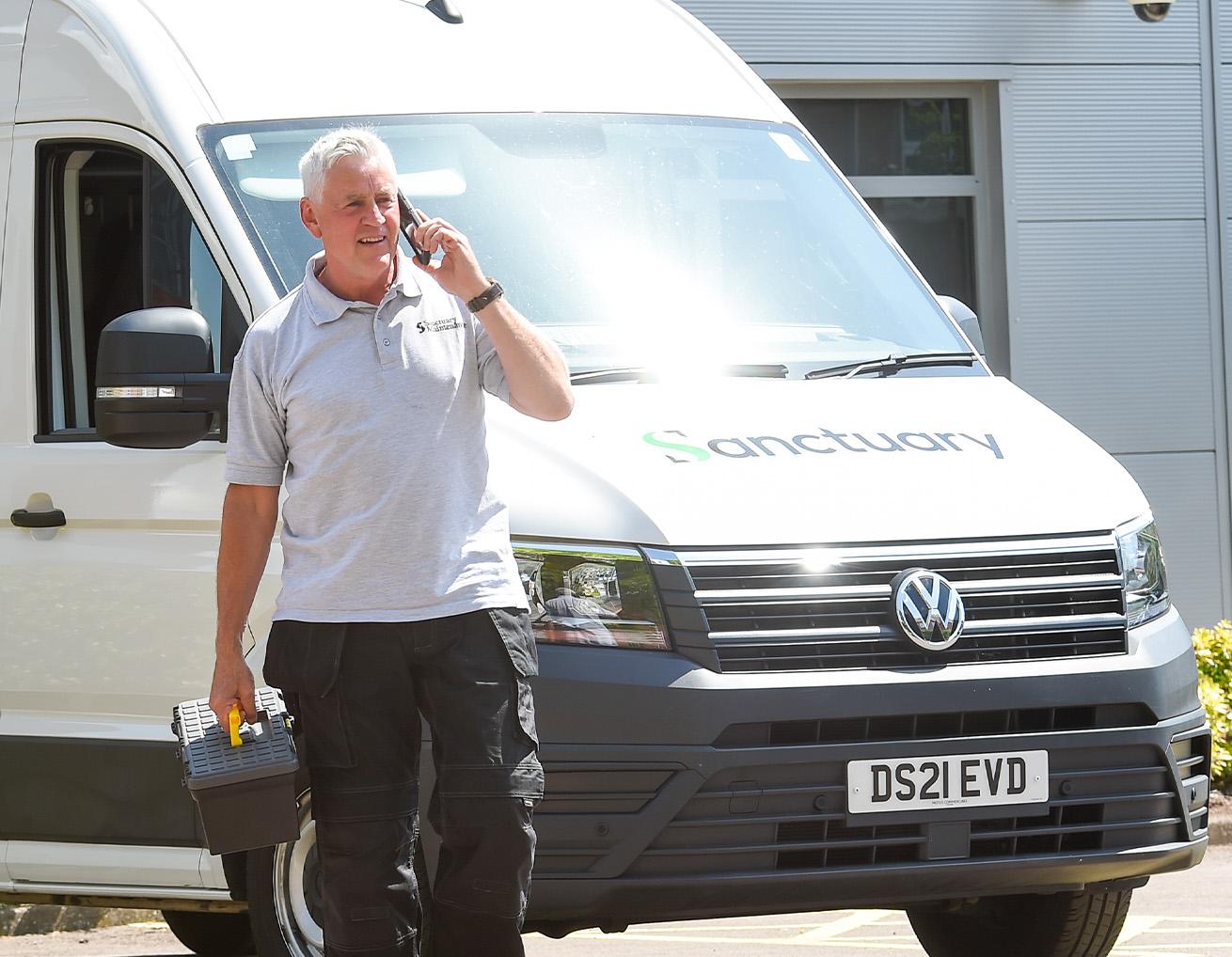 Man walking next to Sanctuary maintenance van Man walking next to Sanctuary maintenance van