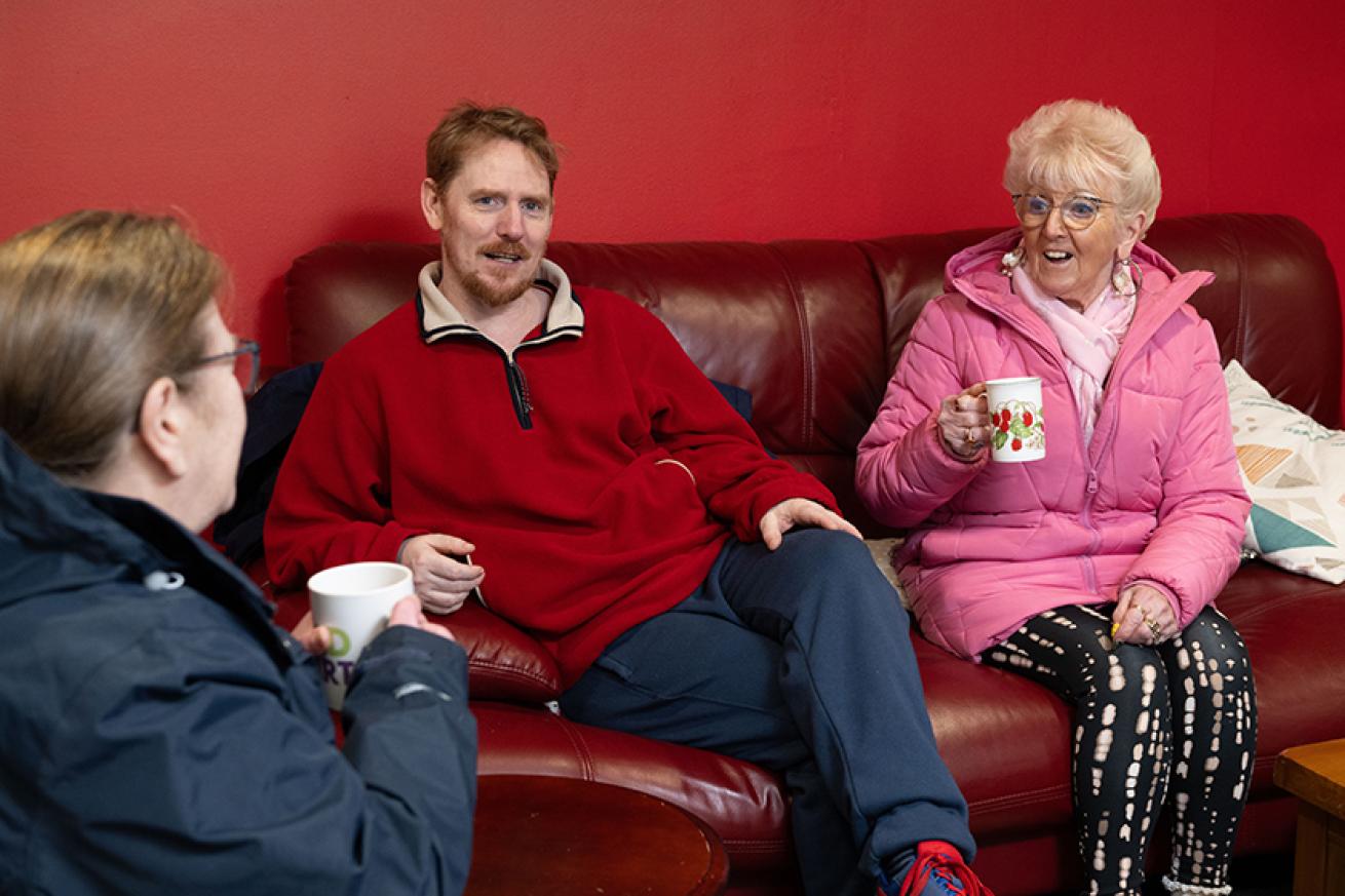 Sanctuary customer group talking on a sofa Sanctuary customer group talking on a sofa