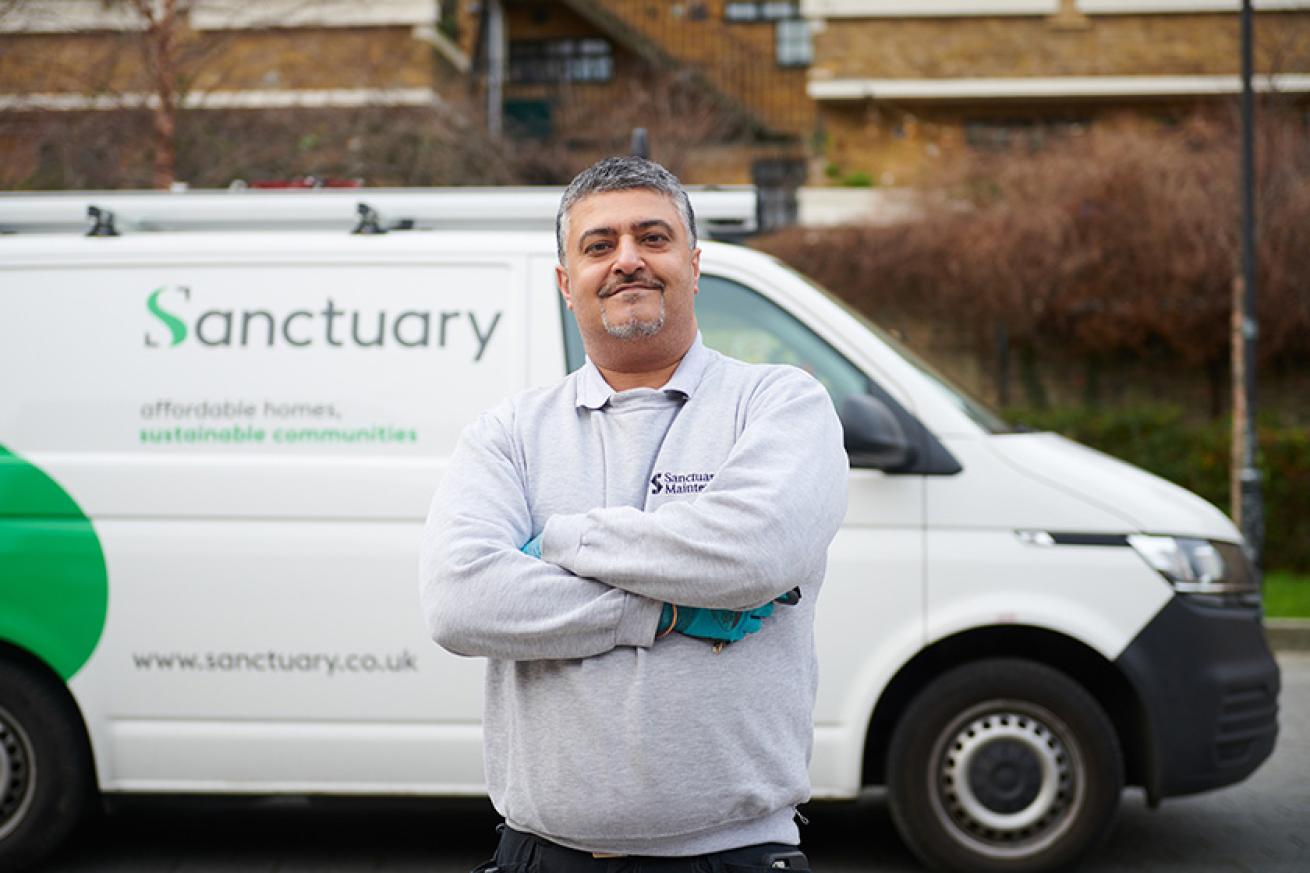 Sanctuary Maintenance employee standing proudly next to a Sanctuary branded van Sanctuary Maintenance employee standing proudly next to a Sanctuary branded van