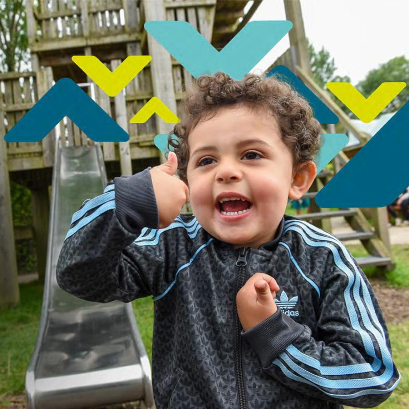 Child in Adidas jacket gives thumbs-up in front of playground slide with colorful geometric shapes overlaid.