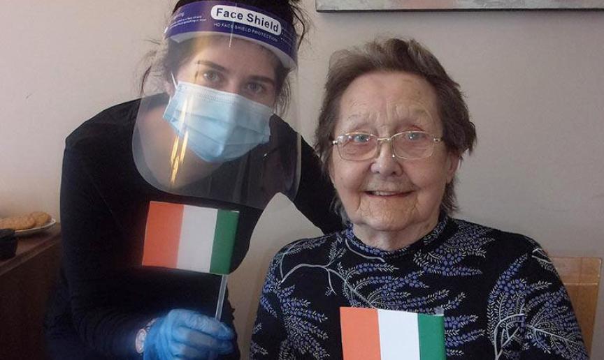 Jessica waves handmade Irish flags with resident, Elsie Jessica waves handmade Irish flags with resident, Elsie