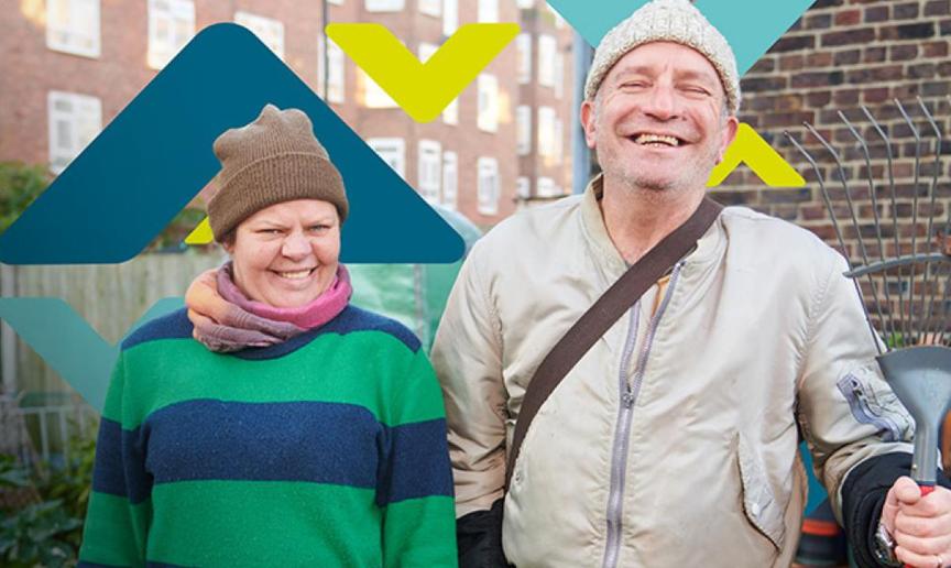 Two residents smiling, standing in an allotment Two residents smiling, standing in an allotment