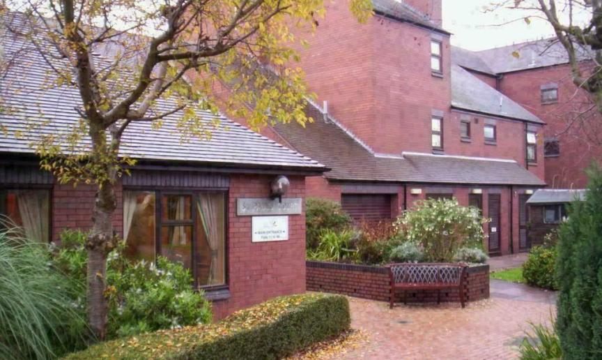 Exterior image of St Pauls Court a dark bricked building in the autumn