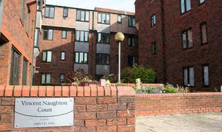A 4 storey apartment building with a courtyard