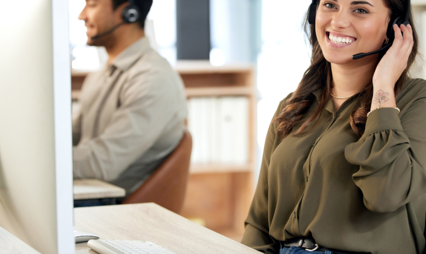 Two colleagues working in a call centre environment 