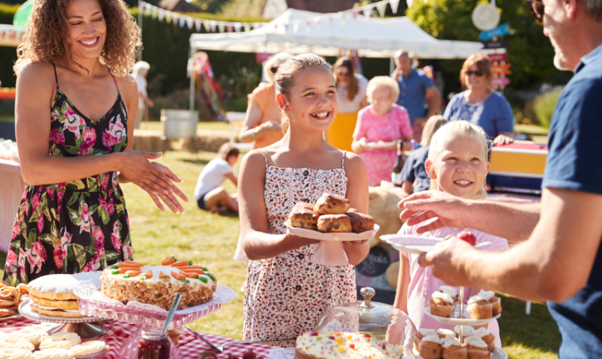 Image of people of all ages enjoying a summer fete on a summers day