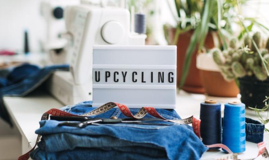 A lightbox placed on a desk spelling out upcycling.