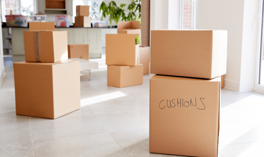 A pile of moving boxes spread across the floor