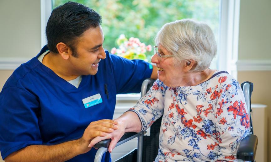 A Care employee and resident looking at each other deep in conversation