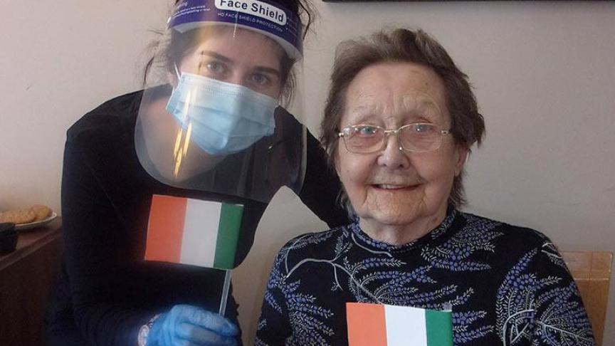 Jessica waves handmade Irish flags with resident, Elsie Jessica waves handmade Irish flags with resident, Elsie