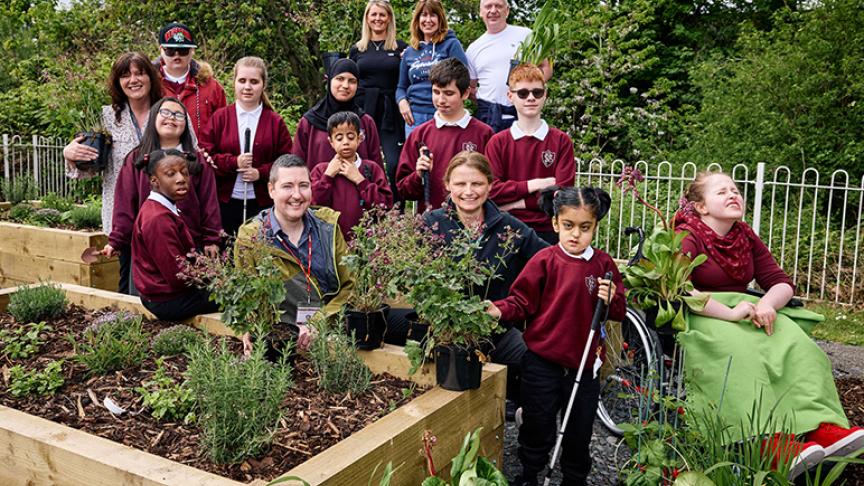 Sensory Garden Group Image A group picture of staff and students from Priestly Smith Specialist School