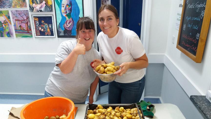 Helpers sort through donated potatoes