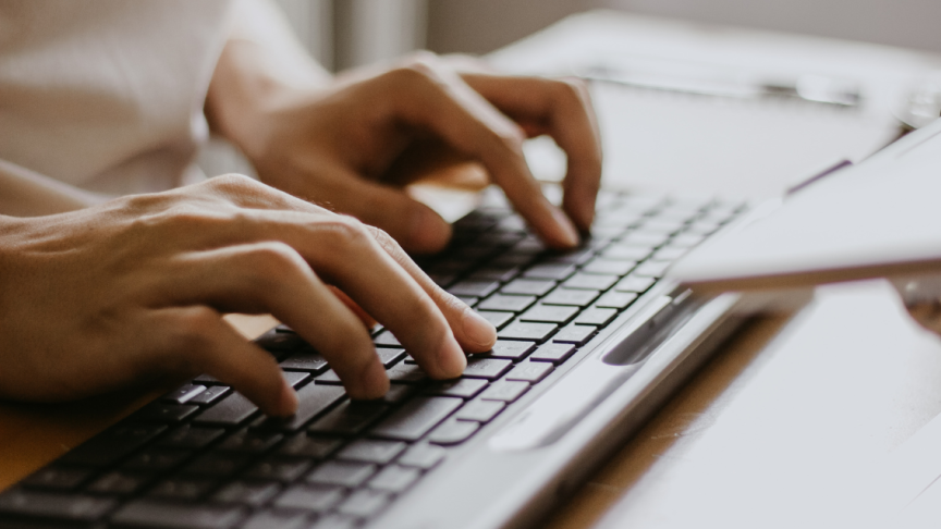 A close up of someone typing on a keyboard