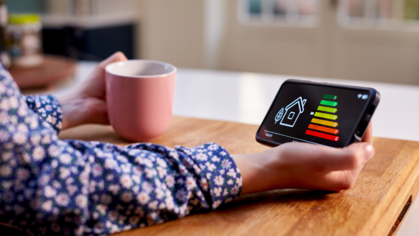 EPC rating A person holding their mobile phone in their hand with an EPC rating on the screen