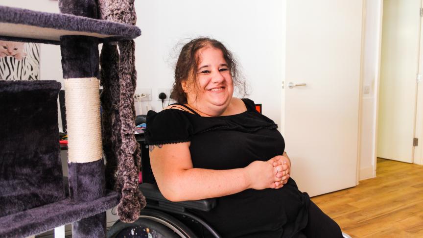 A woman in a wheelchair smiling