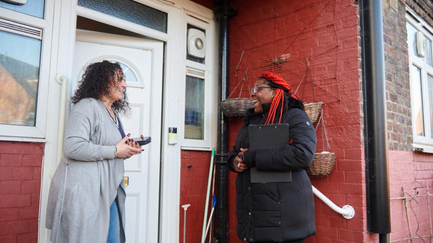 Sanctuary staff speaking to a resident outside their house