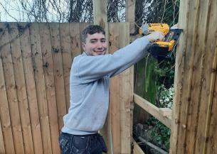 A member of Sanctuary staff putting up new fences for the Acorn Community Centre